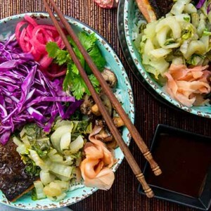 Overhead view of teal bowls filled with Umami Salmon Bowls