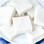 Haupia coconut dessert squares on a white and royal blue plate