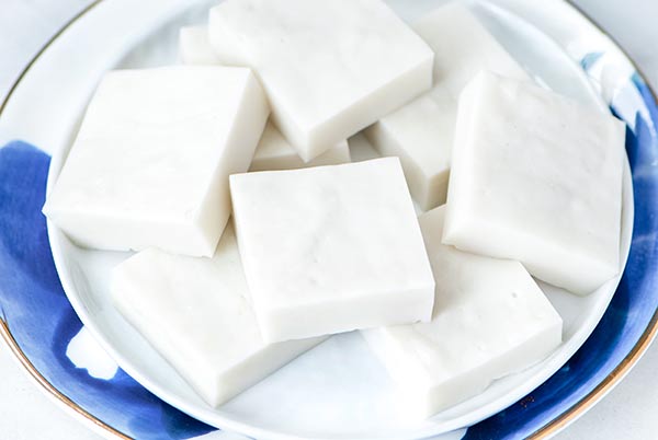Haupia coconut dessert squares on a white and royal blue plate