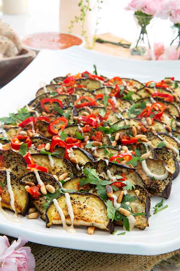 Roasted Eggplant with Tahini and Quick Shatta on a rectangular white serving platter