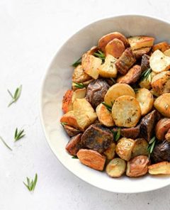 Rosemary Roasted Potatoes in a white bowl on a white background