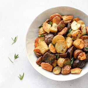 Rosemary Roasted Potatoes in a white bowl on a white background