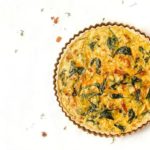 Spinach Bacon and Leek Quiche on a white background