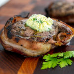 Closeup of Bacon-Wrapped Filet Mignon on a wooden cutting board