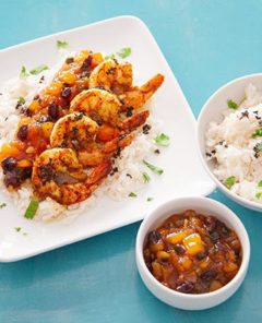 Overhead view of Garam Masala Shrimp on a square white platter with a bowl of white rice and salsa on the side
