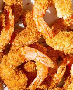 Closeup of Spicy Coconut Shrimp on a white background