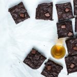 Overhead view of Bourbon Brownies on crinkled parchment paper on a white marble table