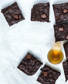 Overhead view of Bourbon Brownies on crinkled parchment paper on a white marble table