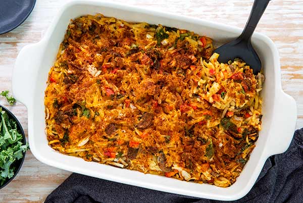 Overhead view of Plant-Based Breakfast Casserole in a white rectangular casserole dish on a light whitewash wood table
