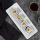 Overhead view of Vegetarian Sushi on a white rectangular plate with a black cloth napkin on a dark gray table