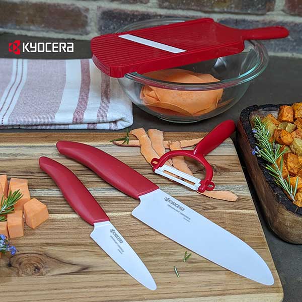 Kyocera Knife Set on a wooden cutting board with chopped sweet potatoes