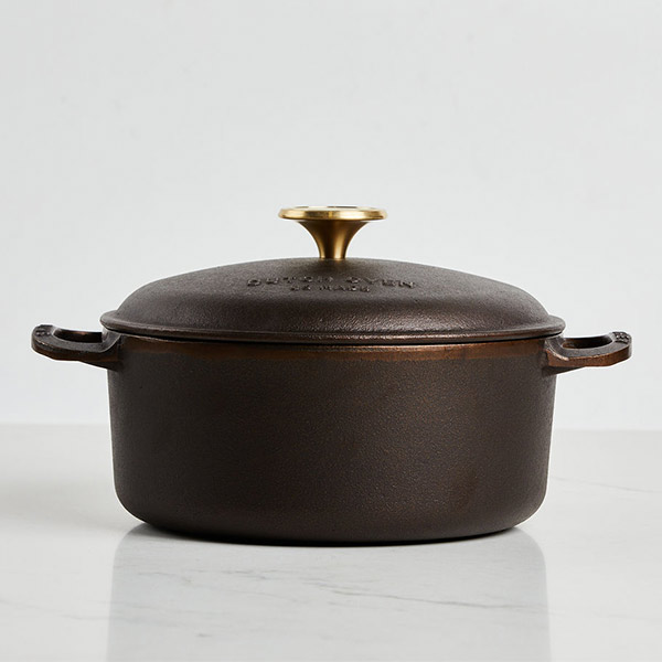 Smithey Dutch Oven on a white marble counter with white background