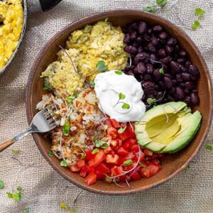 overhead view of Hatch Chili Breakfast bowl in a wooden bowl on a table.