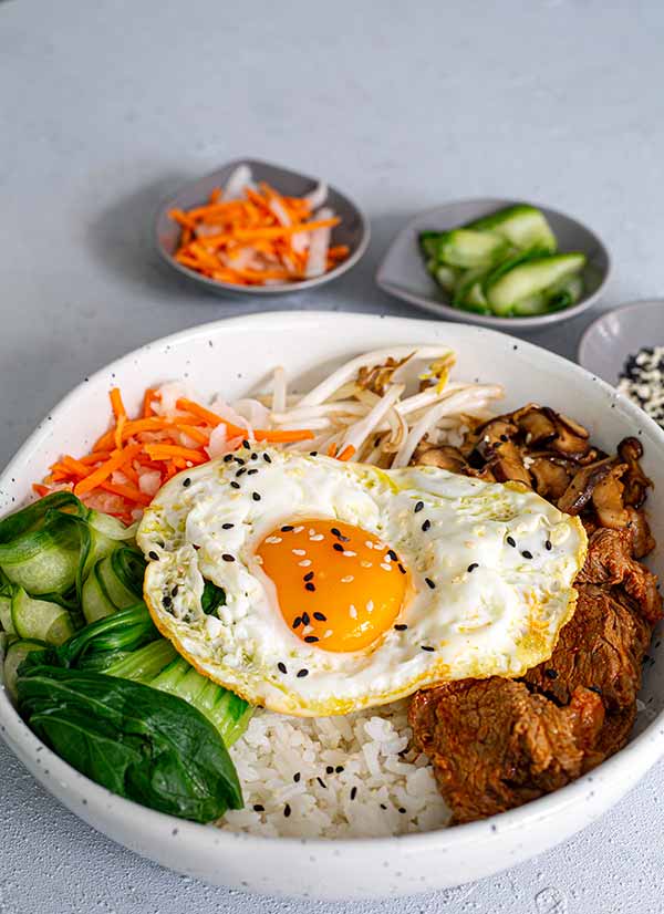 An Overhead view of a bowl of Korean Beef Bipimbop in a white bowl 