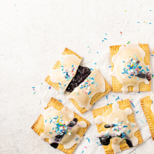 An overhead view of Pop Tarts with one cut in half with the inside filling spilling out.