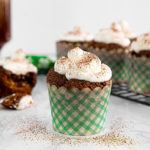 a front view of a irish coffee cupcake in a green checkered cupcake holder
