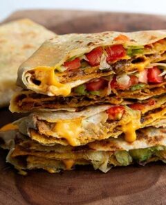 Plant Based Crunch Wraps stacked and cut in half.