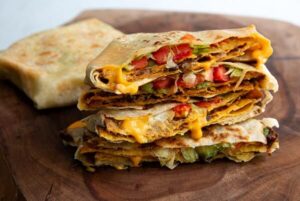 Plant Based Crunch Wraps stacked and cut in half.