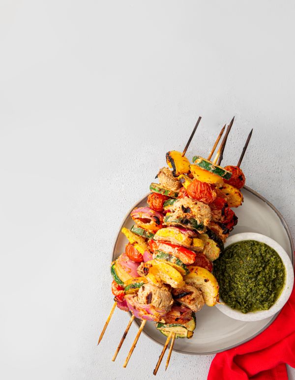 The Tikka Grilled Vegetables on skewers on a white plate.